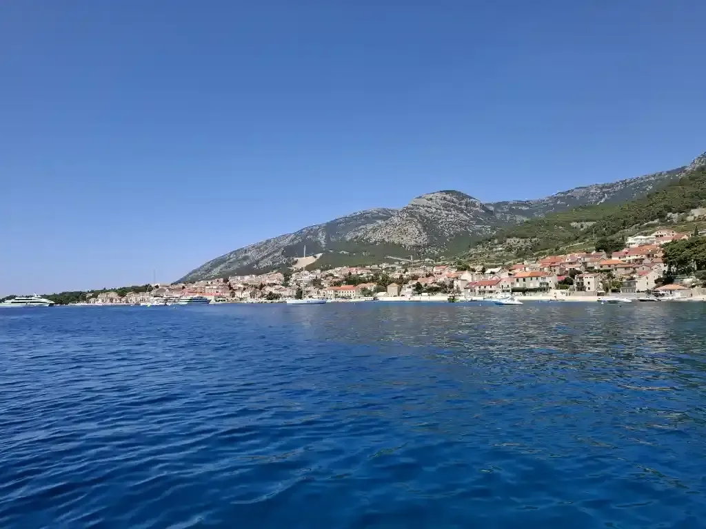 Bol and its red-roofed houses beneath Vidova Gora, seen from the sea
