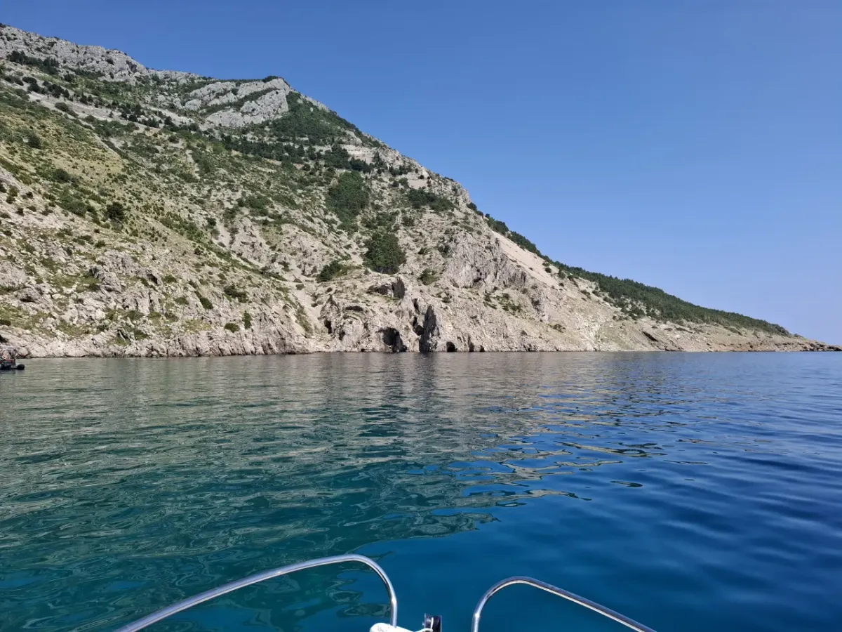 Rugged cliffs and hidden caves along the Vošćica coastline near Brela